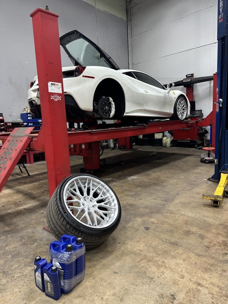 Import Auto Works NJ car lift with imported vehicle undergoing a new tire installation and repair
